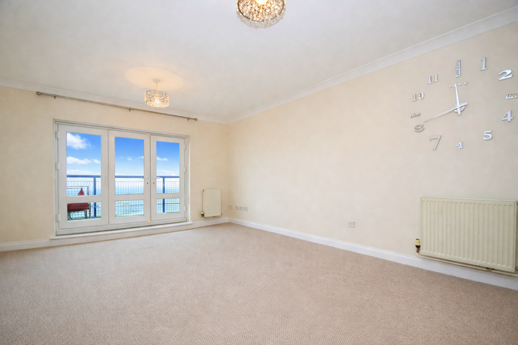 Lot: 73 - TWO-BEDROOM SEAFRONT FLAT WITH PARKING - Living Room looking towards the balcony